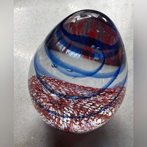 vintage hand-blown art glass egg paperweight with red and blue swirls.
